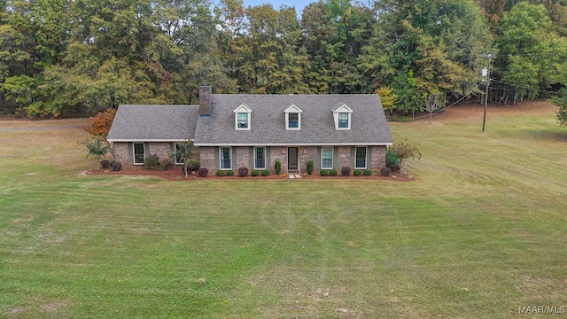 cape cod home with a front lawn