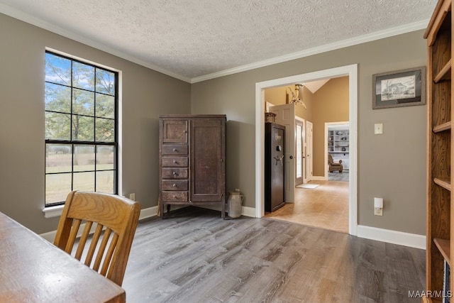 home office with crown molding, light hardwood / wood-style flooring, and a textured ceiling