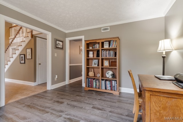 unfurnished office with ornamental molding, a textured ceiling, and wood-type flooring