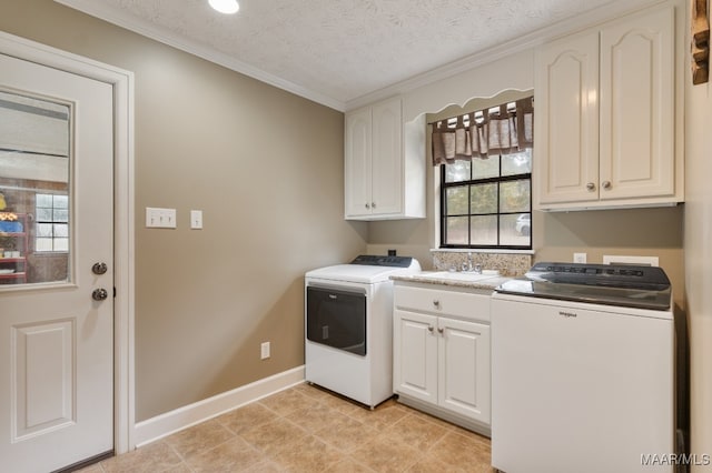 clothes washing area with ornamental molding, sink, a textured ceiling, and cabinets