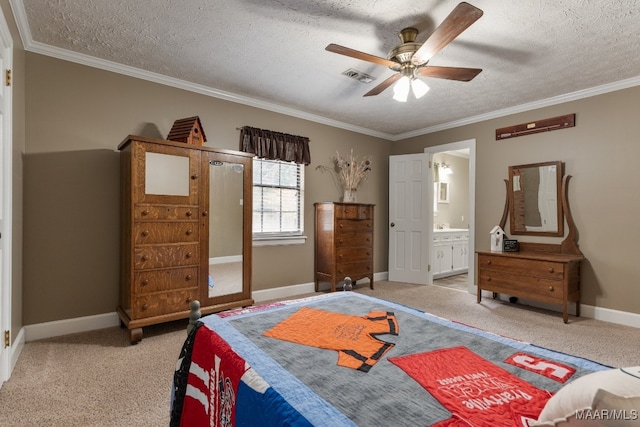 carpeted bedroom with crown molding, a textured ceiling, ensuite bath, and ceiling fan