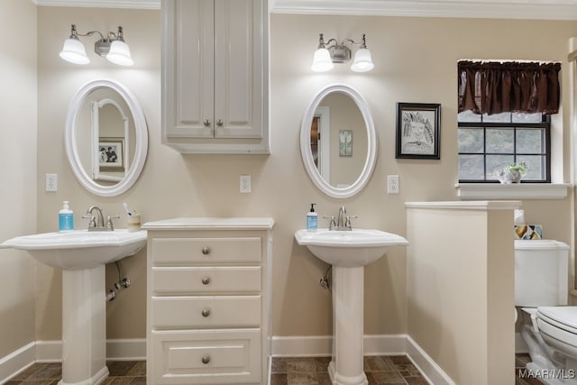 bathroom with toilet, ornamental molding, and sink