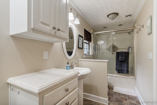 bathroom with toilet, an enclosed shower, a textured ceiling, and vanity