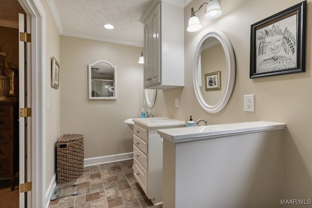 bathroom with vanity, crown molding, and a textured ceiling