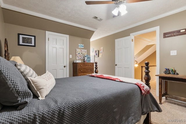 carpeted bedroom featuring ceiling fan, a textured ceiling, ornamental molding, and lofted ceiling