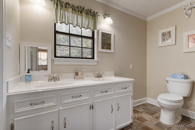 bathroom featuring toilet, ornamental molding, vanity, and a textured ceiling