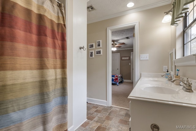 bathroom featuring vanity, crown molding, a textured ceiling, and ceiling fan