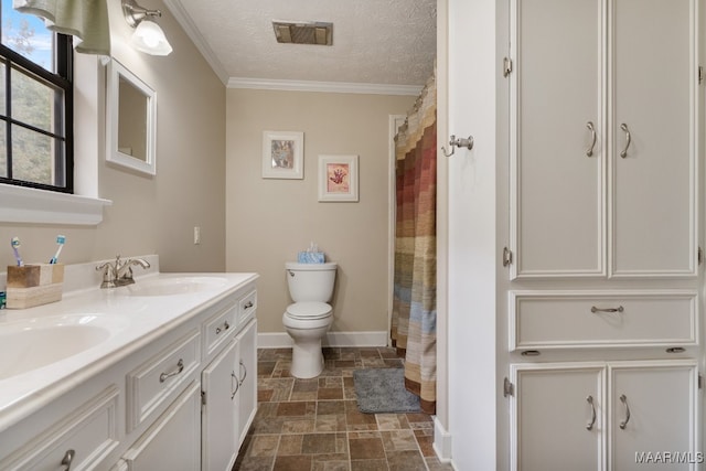 bathroom with vanity, toilet, crown molding, and a textured ceiling