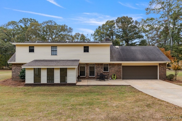 view of property featuring a front yard and a garage