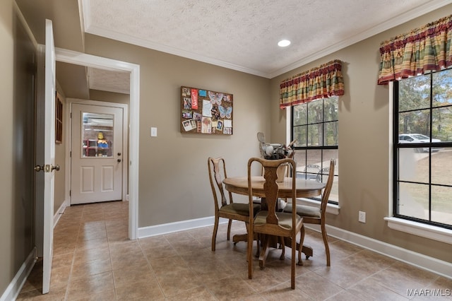 dining area featuring ornamental molding, a textured ceiling, and light tile patterned flooring