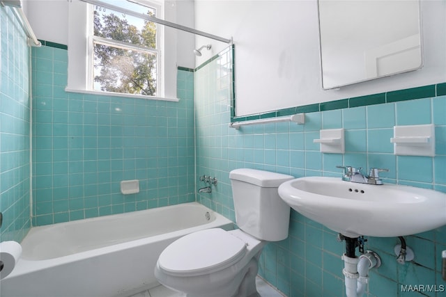 full bathroom featuring toilet, tile walls, and tiled shower / bath