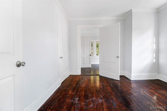 unfurnished room featuring ornamental molding and dark wood-type flooring