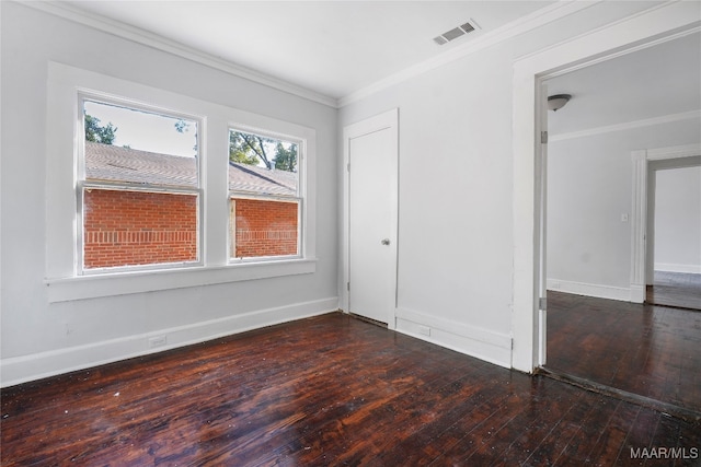 empty room featuring ornamental molding and dark hardwood / wood-style floors