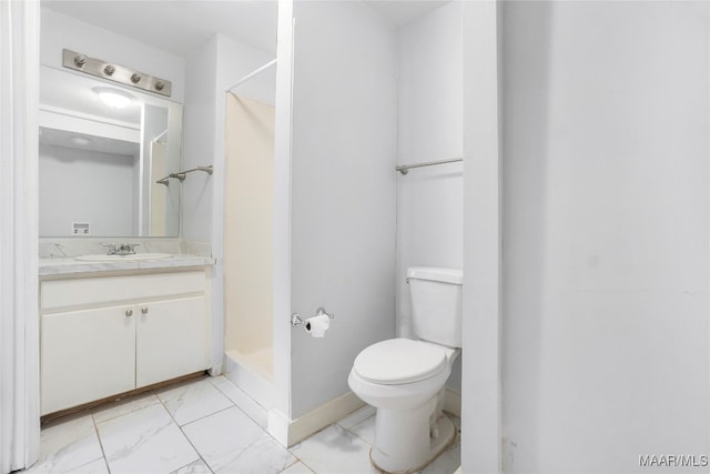 bathroom featuring vanity, toilet, and a shower