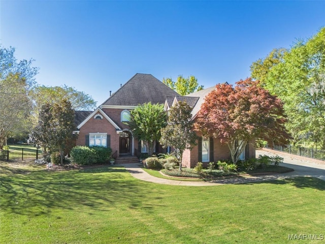 view of front of house featuring a front yard and fence