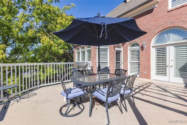 view of patio with grilling area, french doors, and outdoor dining space