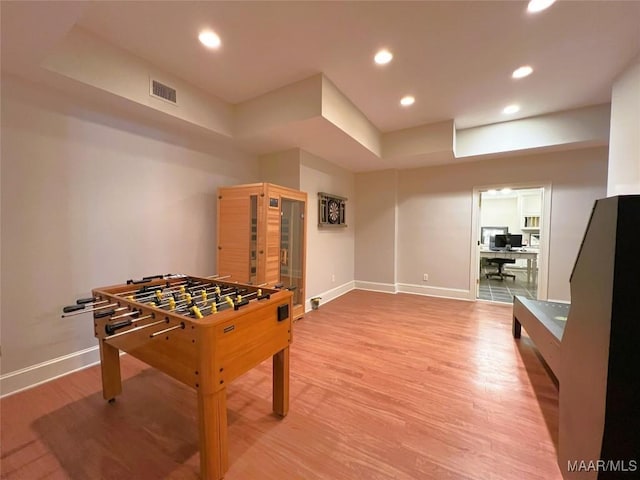 game room with wood finished floors, visible vents, and baseboards