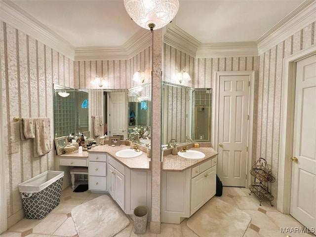 bathroom featuring crown molding, two vanities, a sink, and wallpapered walls