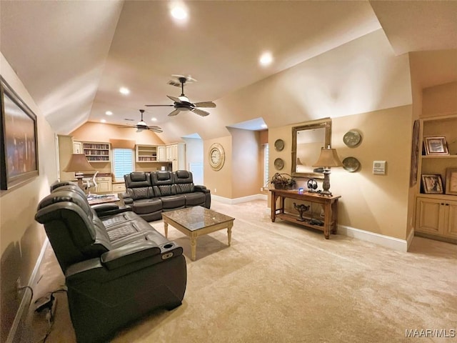 living room with ceiling fan, vaulted ceiling, and light carpet