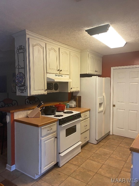 kitchen featuring white cabinets, a textured ceiling, light tile patterned floors, and white appliances