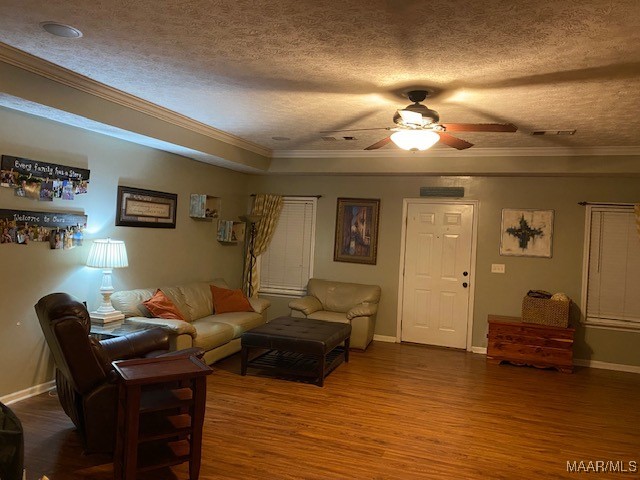 living room with ornamental molding, a textured ceiling, hardwood / wood-style flooring, and ceiling fan