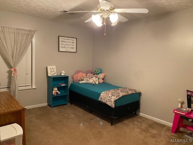 carpeted bedroom with a textured ceiling and ceiling fan