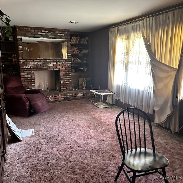 living room featuring carpet and a brick fireplace