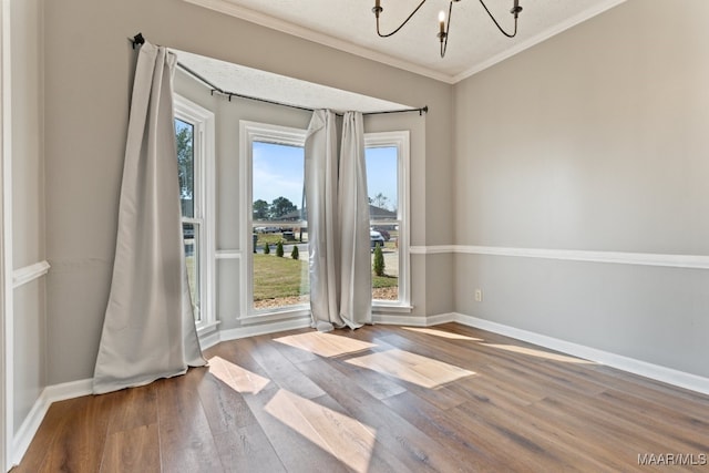 spare room featuring hardwood / wood-style floors, a textured ceiling, and plenty of natural light