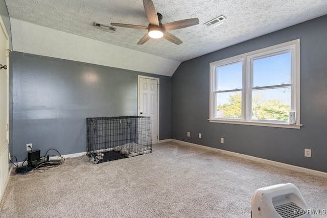 carpeted bedroom featuring ceiling fan, a textured ceiling, lofted ceiling, and a nursery area