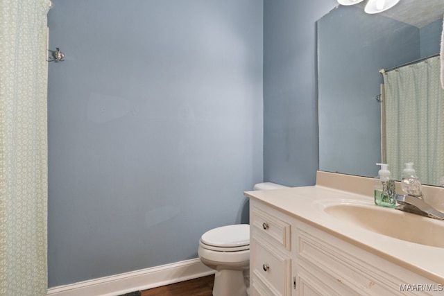 bathroom featuring vanity, hardwood / wood-style floors, and toilet