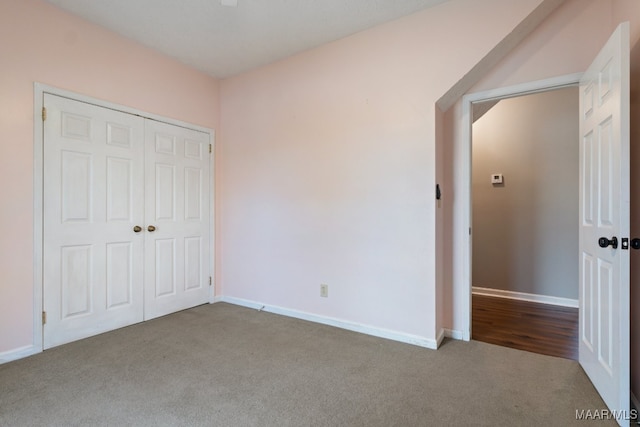 unfurnished bedroom with a closet and carpet floors