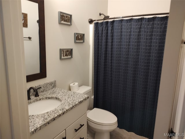 bathroom with vanity, toilet, and walk in shower