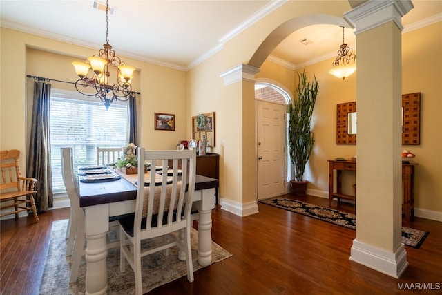 dining area with decorative columns, crown molding, dark hardwood / wood-style floors, and a notable chandelier