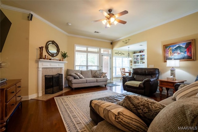 5612 New Harvest Dr, Montgomery, AL 36116 - living area featuring ceiling fan, dark wood-type flooring, a fireplace with flush hearth, ornamental molding, and a chandelier
