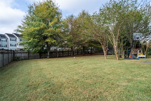 view of yard with a playground and a trampoline