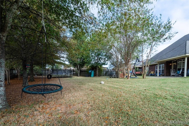 view of yard with a playground and a trampoline