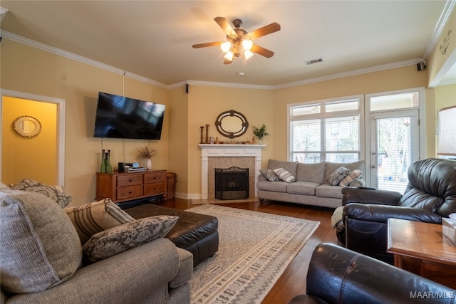 living room with ceiling fan, wood-type flooring, and ornamental molding