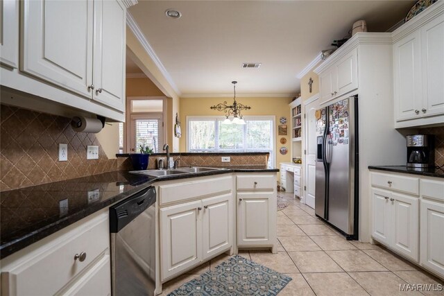 kitchen featuring sink, white cabinets, stainless steel appliances, and ornamental molding