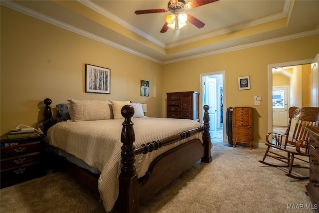 bedroom featuring ceiling fan, ornamental molding, light carpet, and a tray ceiling