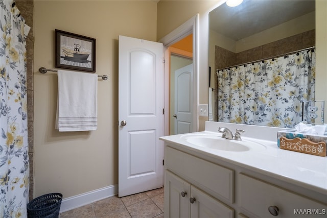 bathroom with tile patterned flooring, vanity, and walk in shower