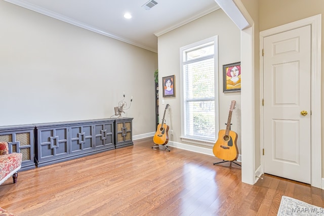 miscellaneous room featuring crown molding and hardwood / wood-style flooring