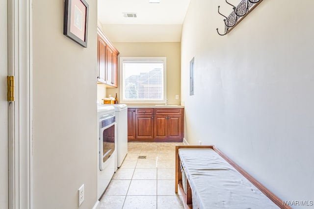 kitchen with sink, independent washer and dryer, and light tile patterned floors