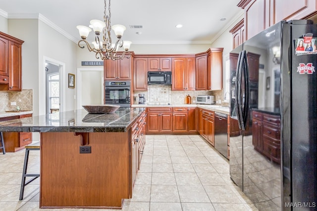 kitchen featuring a kitchen island, ornamental molding, black appliances, a kitchen bar, and light tile patterned floors