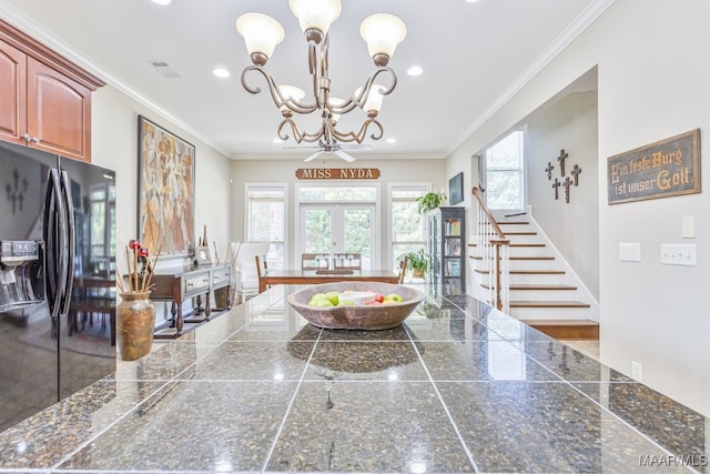 entryway with crown molding, french doors, and a healthy amount of sunlight