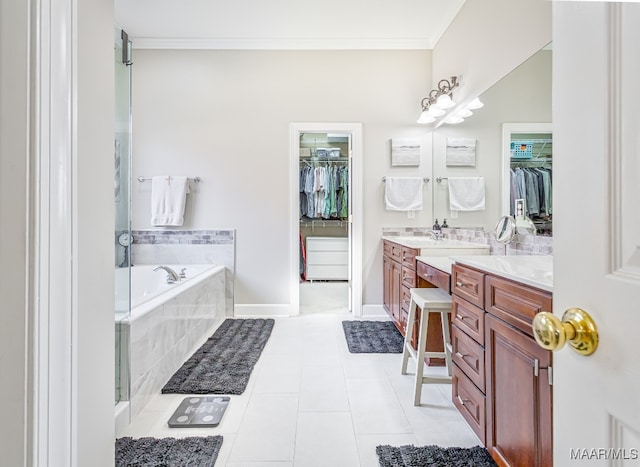 bathroom featuring vanity, a relaxing tiled tub, crown molding, and tile patterned flooring