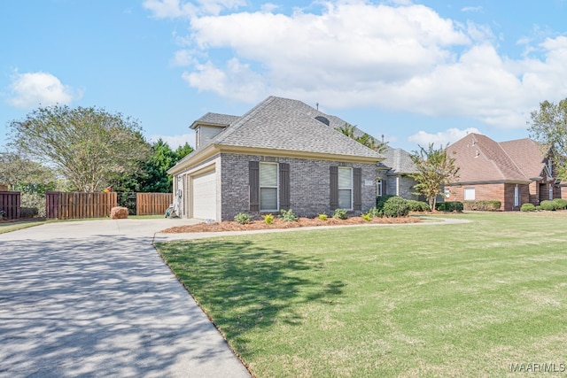 view of front facade with a front yard and a garage