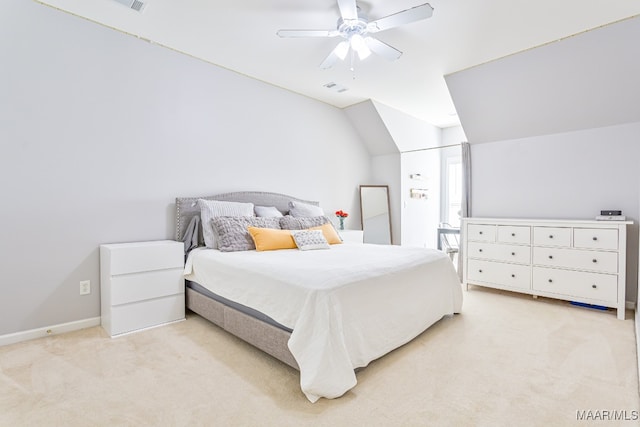 carpeted bedroom featuring a closet, vaulted ceiling, and ceiling fan