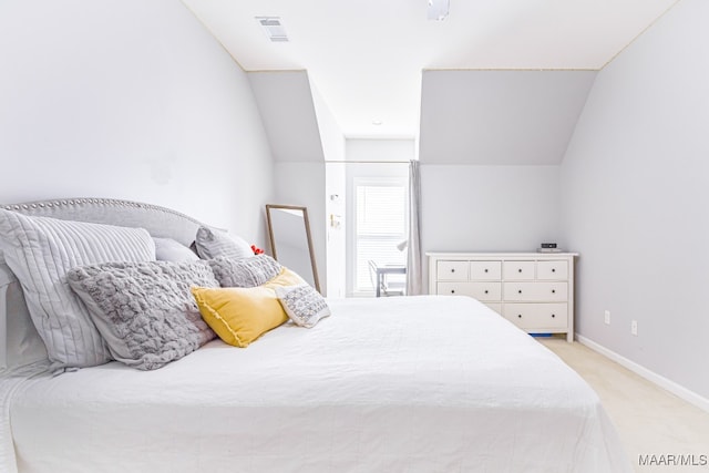 bedroom with light carpet and vaulted ceiling