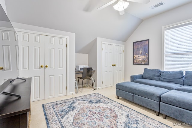 living room featuring ceiling fan, vaulted ceiling, and light colored carpet