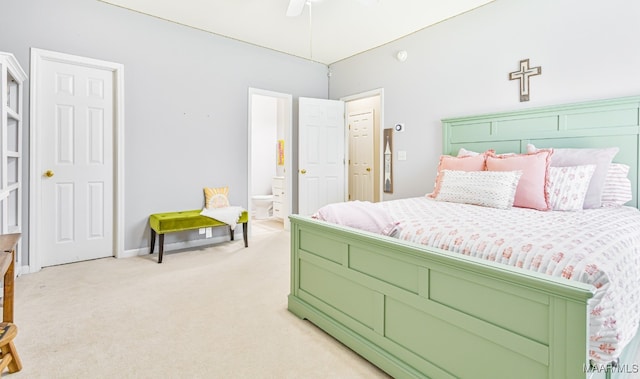 bedroom with light carpet, ensuite bathroom, and ceiling fan